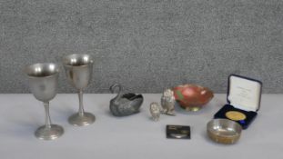 A collection of metal ware. Including two pewter goblets, two silver plated owls and other items.