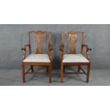A pair of mahogany Chippendale style open armchairs with drop in seats on square stretchered