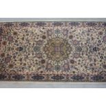 A Persian motif rug with central floral medallion. L.140 W.68cm.
