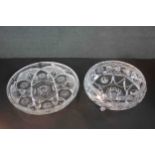 Two hand cut crystal bowls. One on three feet and one large serving dish. They both have a