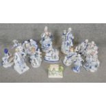 A collection of 12 blue and white gilded porcelain figures. Including a Coalport miniature cottage