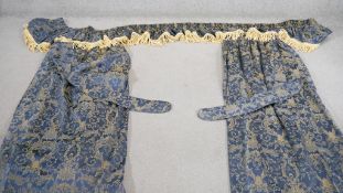 A pair of blue and gold silk mix foliate design curtains with pelmet and tie backs. Silk tassel
