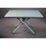 A contemporary metal framed glass top table with height adjustable action retailed by Heal's. H.74