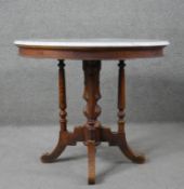 A 19th century Continental walnut centre table with marble top on turned supports on swept quadruped