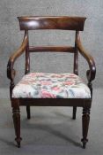 A Regency mahogany bar back armchair with scrolling arms on faceted tapering supports.