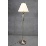 A brushed chrome and brass standard lamp on a circular base. H.147cm