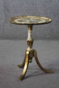 A Florentine style gilt and painted occasional table on swept tripod supports. L.51 Diam.38 cm.