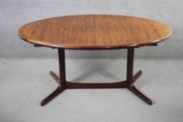 A vintage Danish dining table by Dyrland with two extra leaves and maker's label to the underside.