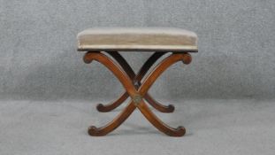 A 19th century mahogany stool on X frame swept supports. H.43 W.44 D.46cm