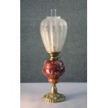 A Victorian relief ceramic and repousse brass rose design oil lamp. With etched tear drop shaped