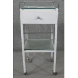 A vintage white painted metal medical table with chrome galleried and plate glass top. H.98 W.40 D.