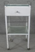 A vintage white painted metal medical table with chrome galleried and plate glass top. H.98 W.40 D.