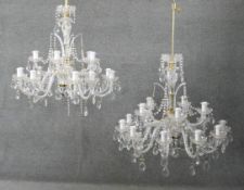 A pair of large blown glass, cut crystal and brass twelve branch chandeliers. Each with