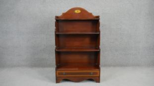 A Georgian style mahogany dwarf bookcase with central satinwood fan patera above open shelves and