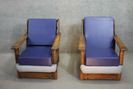 A pair of vintage oak framed Ercol armchairs.