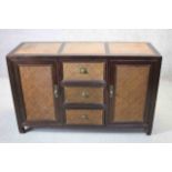 An Eastern hardwood and rattan sideboard on shaped block feet and brass fittings. W.140cm (