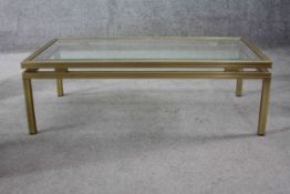 A vintage Maison Jansen style plate glass and brass low coffee table. H.34 W.106 D.55 cm.