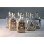 Eight Holmegaard Danish Advent decanters by Michael Bang. Each with a gilded and colourful festive