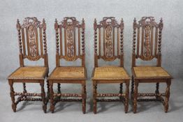 A set of four late 19th century carved oak dining chairs with caned seats on barleytwist stretchered