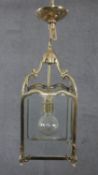 A Victorian style brass and glass plate lantern with foliate motifs and scrolling design. H.55 W.