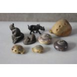 A collection of carved stone and ceramic items. Including three Art Pottery ocarinas, two bronzed