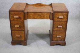 A mid century burr walnut Art Deco style dressing table or writing desk with central frieze drawer