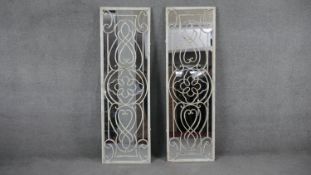A pair of full length mirrors in distressed painted wrought metal frames. H.150 W.31cm