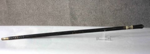 A 19th century Anglo Indian ebony and bone decorated sword stick with relief lion head finial to the