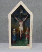 A cased painted and carved wood crucifixion scene with three figures on a painted background. H.70