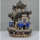 A Chinese tileworks style glazed ceramic mountain temple group with figures. H.46 W.37 D.16cm