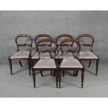 A set of six Victorian acanthus carved mahogany shaped back dining chairs on turned tapering