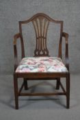 A Georgian mahogany armchair with pierced vase shaped splat and drop in floral upholstered seat on