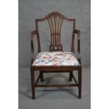 A Georgian mahogany armchair with pierced vase shaped splat and drop in floral upholstered seat on