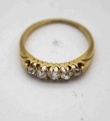 A Victorian 18 carat yellow gold five stone old cut diamond carved half hoop ring. Set with five