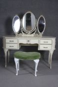 A mid century white lacquered dressing table with triple mirror on carved cabriole supports along