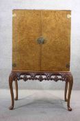 A mid century burr walnut Epstein drinks cabinet with glazed and fitted interior and pull out mixing