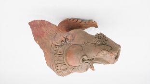 An Oriental terracotta mythical creatures head. H.30 W.19cm