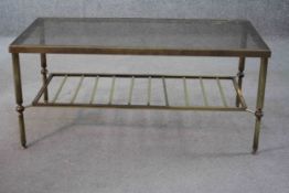 A mid century vintage smoked glass and brass coffee table with slatted magazine rack undertier. H.40