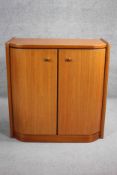 A contemporary teak two door cabinet. H.89 W.87 D.42cm