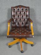 A Georgian style office armchair in deep buttoned leather upholstery with tilt and swivel action.