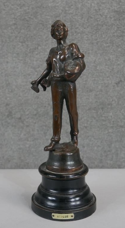 A bronze figure of a farm boy feeding chickens mounted on an ebonised base. Plaque reads Semeur. H.