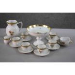 A six person Royal Copenhagen gilded and hand painted floral design coffee set. Along with