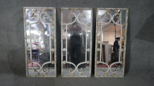 A set of three garden mirrors in distressed painted wrought metal frames. H.100 W.50cm