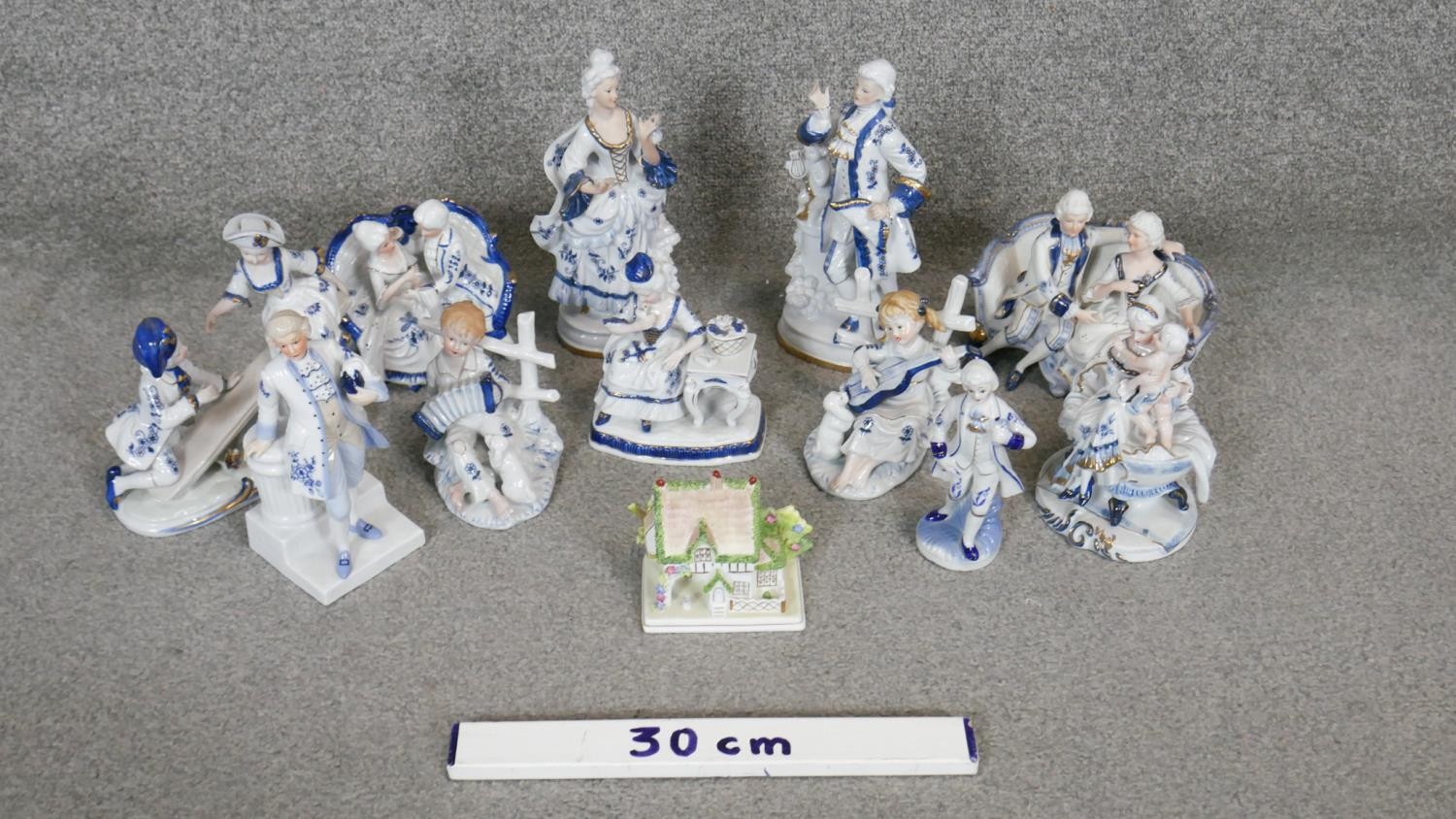 A collection of 12 blue and white gilded porcelain figures. Including a Coalport miniature cottage - Image 2 of 7