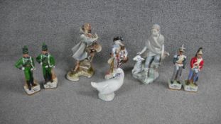 A collection of eight hand painted porcelain figures. Including a Lladro figurine of a shepherd