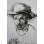A framed and glazed print of charcoal portrait of a man in a hat. Signed E. Monaco, 1967. H.80 x W.