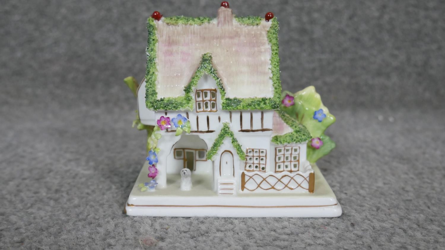 A collection of 12 blue and white gilded porcelain figures. Including a Coalport miniature cottage - Image 6 of 7