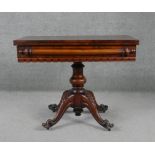 A mid 19th century mahogany tea table with swivel top action raised on baluster turned pedestal