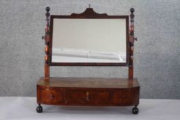 A mid 19th century mahogany toilet mirror with shaped base fitted with drawers on bun feet. H.56 W.