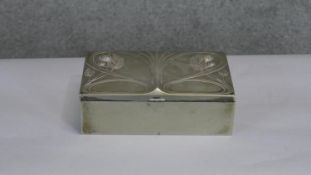 An Art Nouveau silver plated cedar lined cigar box with a raised pine cone and fir branch flowing